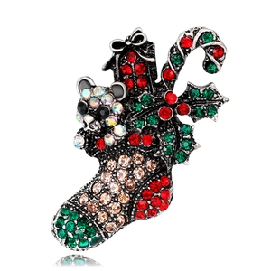 Detail of Christmas stocking brooch with rhinestones, panda and candy cane motifs