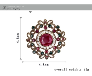 Detail of luxury vintage round brooch with red crystal and 4.8cm size measurement