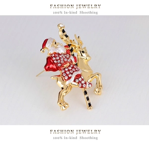 Close-up of Santa Claus on reindeer brooch with red enamel and sparkling rhinestones