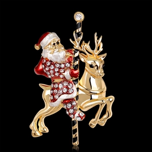 Christmas carousel brooch with Santa and reindeer in gold metal and sparkling crystals