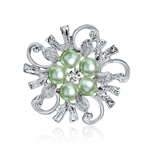 Elegant floral silver brooch featuring light green pearls and a central sparkling crystal