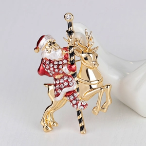 Elegant Christmas brooch featuring Santa on a golden reindeer with sparkling rhinestones