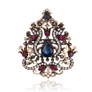 Broche de corona dorada vintage con gema azul de gota y patrones de filigrana fina