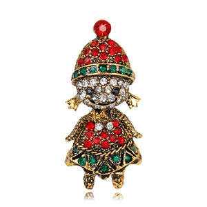 Detail of Christmas girl brooch with red and green rhinestones on vintage gold base