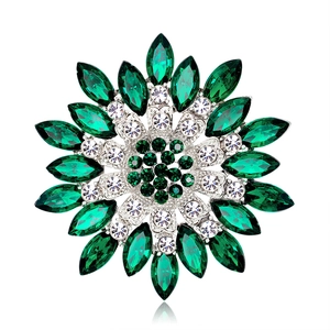 Macro shot of emerald flower brooch with silver metal base and rhinestone petals