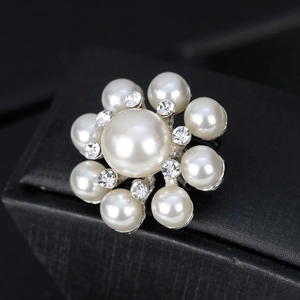 Broche florale élégante avec perles et strass sur un présentoir de boîte à bijoux noire