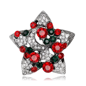 Detail of Christmas star brooch featuring festive red and green rhinestones on alloy base