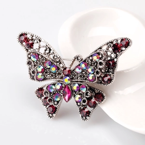 Vintage butterfly brooch with deep red and AB rhinestones on a silver openwork metal base