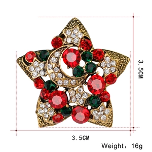 Detail of vintage star brooch with red and green crystals, 3.5cm size and 16g weight