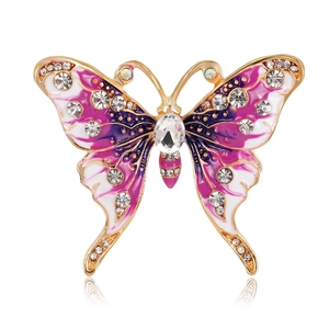 Vintage gold butterfly brooch with purple enamel wings and sparkling crystal accents