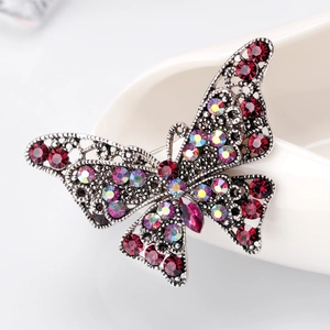 Vintage butterfly brooch in silver alloy with sparkling red and AB rhinestones