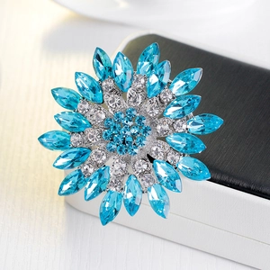 Elegant sunflower brooch with sky blue marquise crystals and silver metal setting