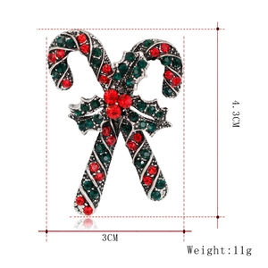 Detailed size view of a Christmas candy cane brooch with red and green rhinestones