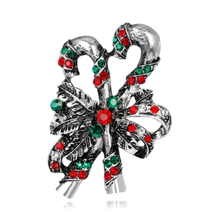 Detail shot of vintage silver candy cane brooch with festive colorful rhinestones and bow
