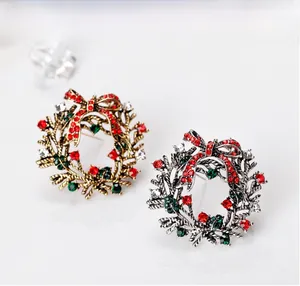 Macro shot of vintage style Christmas wreath brooch with red rhinestone bow detail