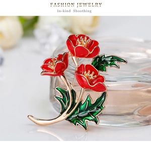 Detailansicht einer Mohnblumen-Brosche mit roter Emaillierung und goldenem Finish