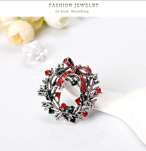Detail of a Christmas wreath brooch with sparkling red and green rhinestones