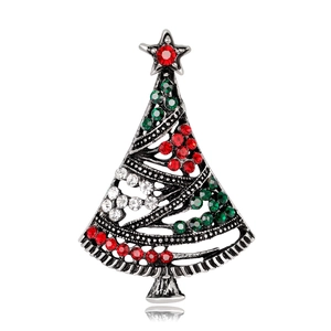 Detail of Christmas tree brooch with red and green rhinestones on vintage silver alloy