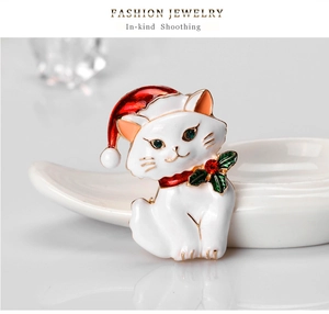 Detail of Christmas cat brooch with white enamel finish and sparkling rhinestone accents