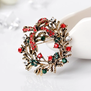 Christmas wreath brooch with sparkling red rhinestones and golden holly leaves design