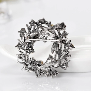 Back view of silver alloy Christmas wreath brooch with diamond accents and pin closure