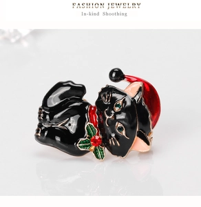 Detail of a Christmas black cat brooch with red hat and sparkling crystal accents
