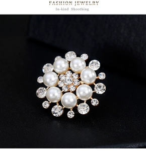 Macro detail of elegant floral pearl brooch with sparkling rhinestones on gold base