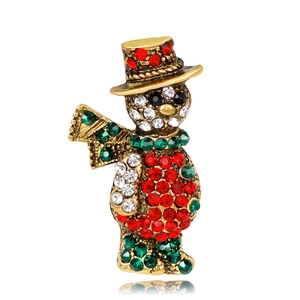 Macro detail of Christmas snowman brooch with colorful rhinestones on gold alloy base