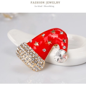 Detailed view of Christmas hat brooch with red enamel and sparkling crystal rhinestones
