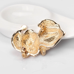 Reverse view of vintage gold cat brooch showing secure safety pin and metallic texture