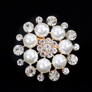 Elegant sunburst pearl brooch with shimmering crystals on a gold-plated flower base