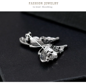 Detail view of the vintage silver butterfly brooch back with pin clasp mechanism