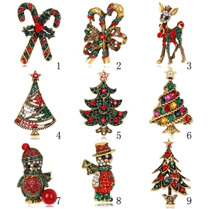 Collection of Christmas brooches with festive trees and snowmen in gold and rhinestones