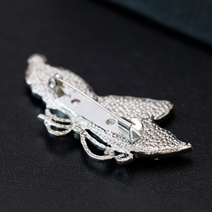 Silver butterfly brooch with textured alloy back and secure metal pin fastening