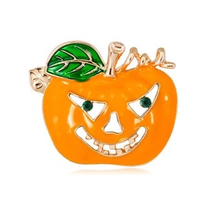 Vue détaillée de la broche citrouille en émail orange et yeux en strass verts brillants
