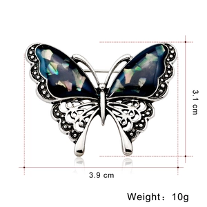 Elegant butterfly brooch with iridescent shell wings, 3.9cm width and 10g silver metal frame