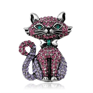 Vintage style pink cat brooch with colorful rhinestones and silver finish on white background