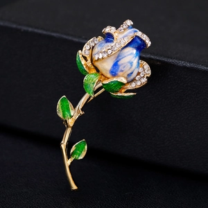 Broche élégante en forme de rose avec émail bleu et cristaux brillants sur monture dorée