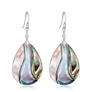 Macro detail of teardrop abalone shell earrings with natural iridescent texture and silver hooks