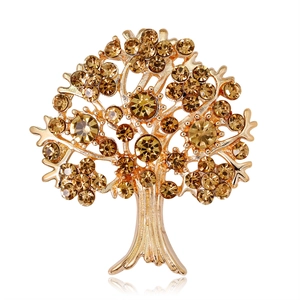 Spilla albero della vita dorata con strass color ambra su sfondo bianco neutro