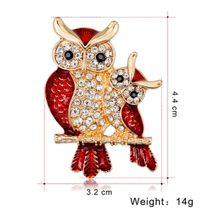 Golden owl brooch with red enamel and sparkling crystals, dimensions 4.4cm by 3.2cm