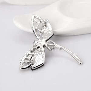 Vintage silver dragonfly brooch showing back pin closure and hollowed-out wing craftsmanship