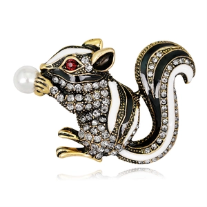 Sparkling crystal squirrel brooch with enamel finish and pearl accent on white background