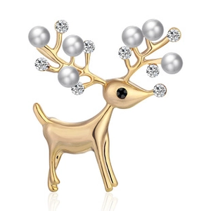 Macro shot of reindeer brooch with gold plating, white pearls and crystal details