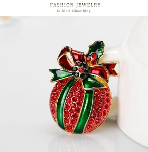 Detailed view of Christmas brooch with red-green bow and sparkling rhinestones