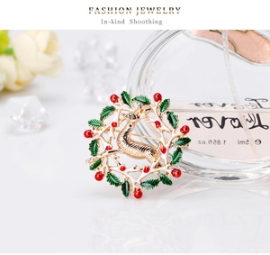 Détail de la broche couronne renne de Noël en émail vert avec un œil en cristal brillant