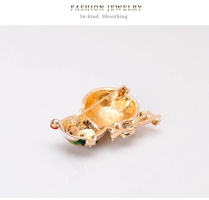 Detailed back view of a golden Christmas snowman brooch with a secure metal pin clasp