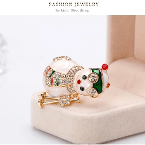 Macro detail of cartoon snowman brooch with colorful enamel and sparkling rhinestones