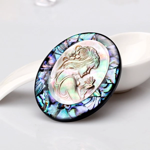 Exquisite oval abalone shell cameo brooch featuring a carved girl portrait on white porcelain