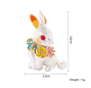 Detail view of rabbit brooch with size specs 3.6x2.3cm and white enamel finish